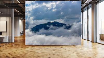 caucasian mountains and cloudy sky on a summer day Wall mural