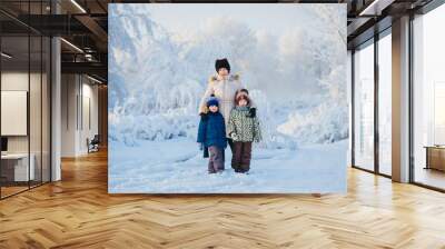 two boys and a grandmother in the winter forest Wall mural