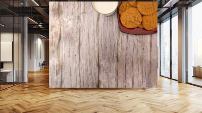 overhead composition with plate of cookies and glass of milk on a light wooden background Wall mural