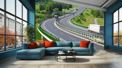 The highway between woods, electronic toll gates, moving trucks Wall mural