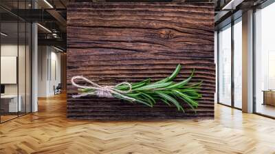 Fresh fragrant rosemary branch on vintage wooden table Wall mural