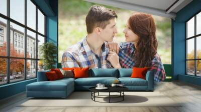 Flirting young couple on a bench Wall mural