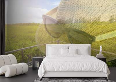 double exposure of glasses with hat on nature background for jou Wall mural