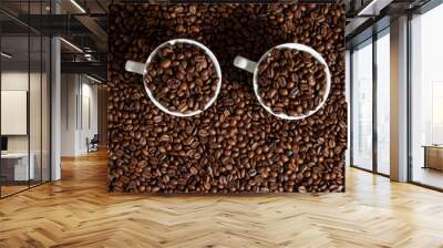 two cups of coffee on coffee beans on a brown background. Wall mural