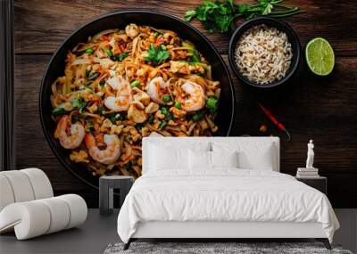 Overhead View of Pad Thai with Shrimp Peanuts and Lime on Rustic Wooden Background Wall mural