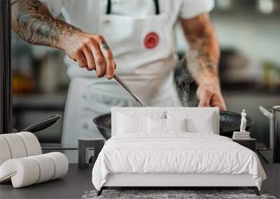 Tattooed Chef Stirring Steaming Vegetables in Black Pan Closeup Perspective Focus on Hand and Food Wall mural