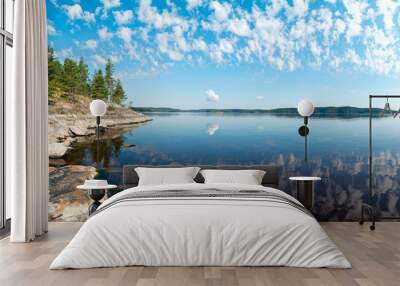 Rocky shore of the island on lake Ladoga with the reflection of clouds . Ladoga Skerries, Karelia Wall mural