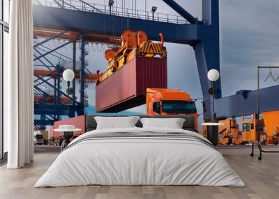 The container vessel during loading at an industrial port by port crane. Wall mural