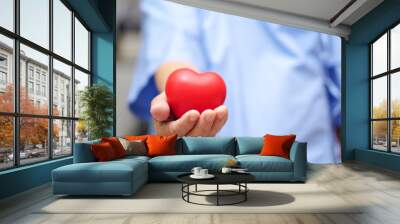 Asian senior or elderly old lady woman patient holding red heart in her hand on bed in nursing hospital ward : healthy strong medical concept  Wall mural