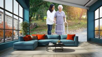 Asian senior or elderly old lady woman patient walk with walker in park : healthy strong medical concept  Wall mural