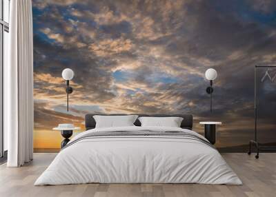 panorama blue sky with a cloud texture and setting sun over the sea with relaxing background Wall mural