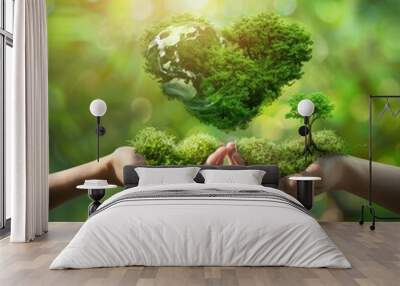 two hands holding earth globe and heart shape of tree over blurred green nature background Wall mural