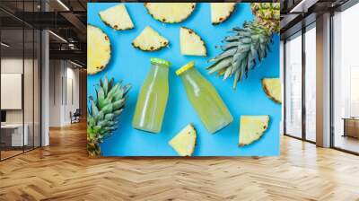 Tropical composition with pineapple and juice in bottle, flat lay Wall mural