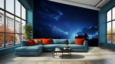 A beautiful clean dark blue night sky with stars and clouds above field of trees. evening sky, night view. illuminated moon. Dark black night. cosmos background. Wall mural