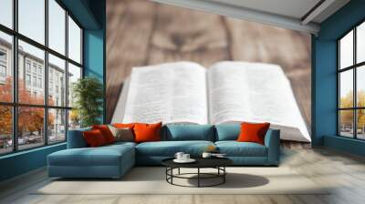 Open Bible. Holy Bible, Scripture. An open old book of the Holy Bible on the table. Rays of light shine on the book. Prayer and faith in God. Symbol of Christianity. Wall mural