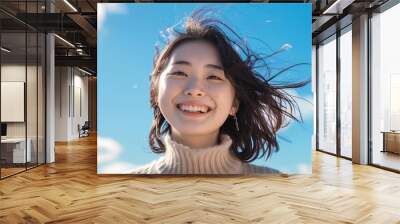 Beautiful Asian Korean woman with her smile on a sky blue background Wall mural