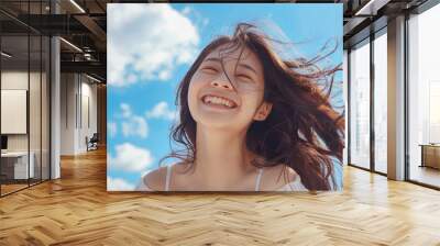 Beautiful Asian Korean woman with her smile on a sky blue background Wall mural