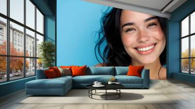 beautiful woman with her smile on a sky blue background Wall mural