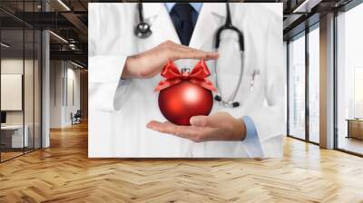 Merry Christmas from doctor,, best wishes concept, hands with xmas red ball, gift card banner web Wall mural