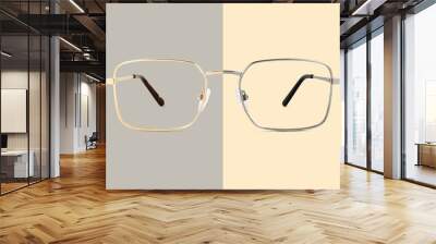 Silver and golden metal color eye glasses isolated on beige and gray background, ideal photo template for display or advertising sign or for a web banner Wall mural