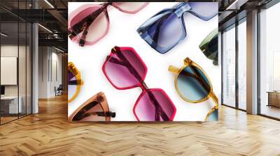 Sunglasses composition in many bright colors in transparent plastic. Top view with shadow. Trendy glasses isolated on white background. Glasses with polarized lenses. Fashionable eyewear for women. Wall mural