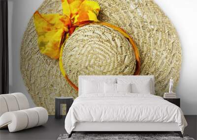 top view female summer straw hat with ribbon and yellow bow, isolated on white background Wall mural