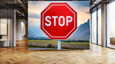 stop sign on a road.a red octagon stop sign isolated on a white background, with a focus on the geometric precision and the universal symbolism of the stop sign as a road safety measure. Wall mural