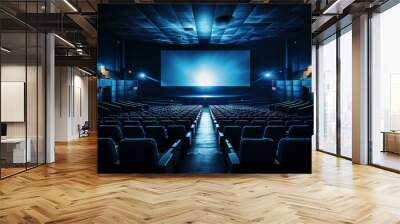 Blue cinema hall with white blank screen and empty seats. Concept of movie theater, entertainment, and leisure. Wall mural