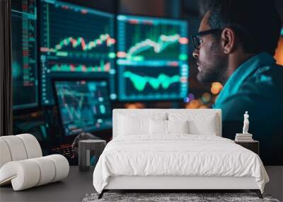 Focused trader analyzing live stock market graphs on computer monitor for strategic investment planning Wall mural