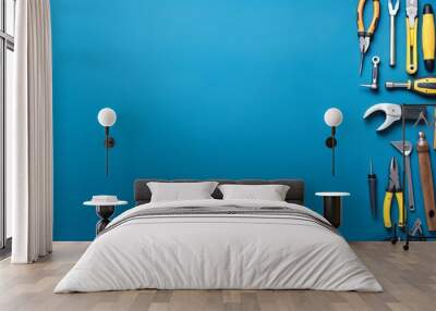 various handy tools arranged on bright blue background with copy space, concept of diy, home improve Wall mural