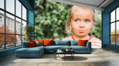 Toddler girl portrait in garden Wall mural