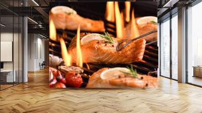 Grilled salmon fish with various vegetables on the flaming grill Wall mural