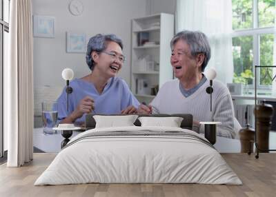 Happy Asian senior couple eating meal together in kitchen at home. Retirement senior couple lifestyle living concept. Wall mural