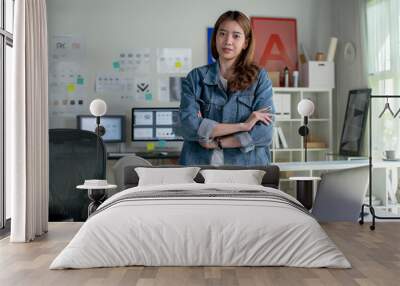 Portrait of Asian female graphic designer looking at camera in office. Wall mural