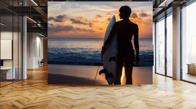 woman surfer with surfboard on tropical beach at sunset Wall mural