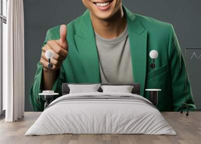 a man in a green color formal outfit standing in a studio Wall mural