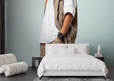 a man in white white casual outfit standing in the studio with isolated background Wall mural