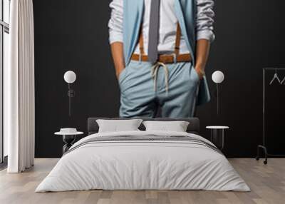 Smiling man in a blue color formal outfit standing in a studio Wall mural