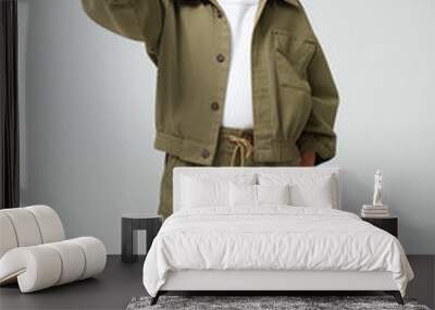 young Asian kid wearing a green outfit, isolated on a white isolated background Wall mural