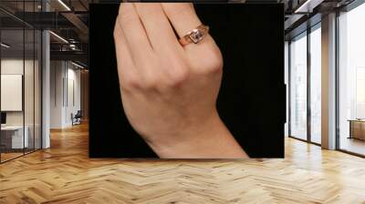 female hand holding fingers diamond ring Wall mural