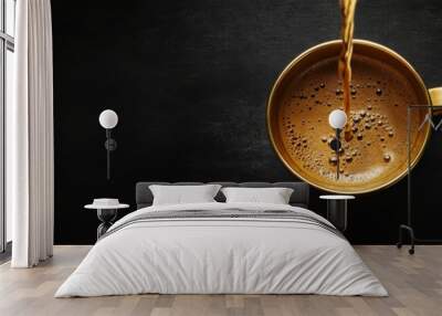 A stunning topdown view shows rich coffee poured into a golden cup, contrasted against a sleek black background. Ideal for coffee lovers and those who appreciate coffee art and aesthetics Wall mural