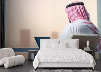 arab saudi man using laptop, back view Wall mural