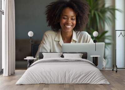 beautiful black business woman sitting in front of laptop and smiling Wall mural