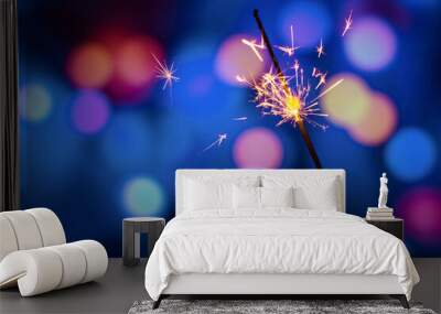 Bengal fire burning on a color blurred background. Firework salute. Festive new year background. Wall mural