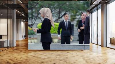 Portrait of cheerful happy businesswoman wearing black suit  standing  and holding tablet Wall mural