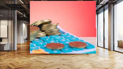 Stacking coins on calculator over beautiful reverberation gradient background for saving business investment concept Wall mural