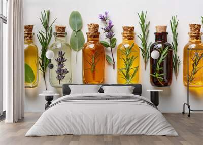 A row of essential oil bottles with natural herbs and flowers on a white background, showcasing organic aromatherapy ingredients. Wall mural