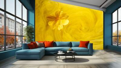 Abstract yellow background with flowers and paints in water. Backdrop for perfume, cosmetic products Wall mural