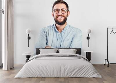 Friendly face portrait of an authentic caucasian bearded man with glasses of toothy smiling dressed casual against a white wall isolated Wall mural