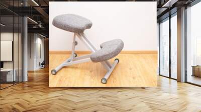 Orthopedic ergonomic kneeling chair close-up on home wall background, back health care Wall mural